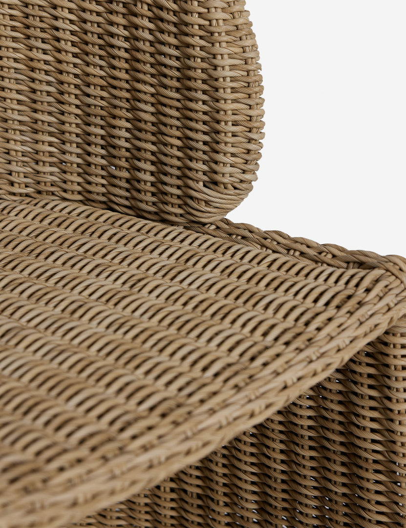 #color::natural | Close up of the seat of the Mettam modern wicker outdoor dining chair.
