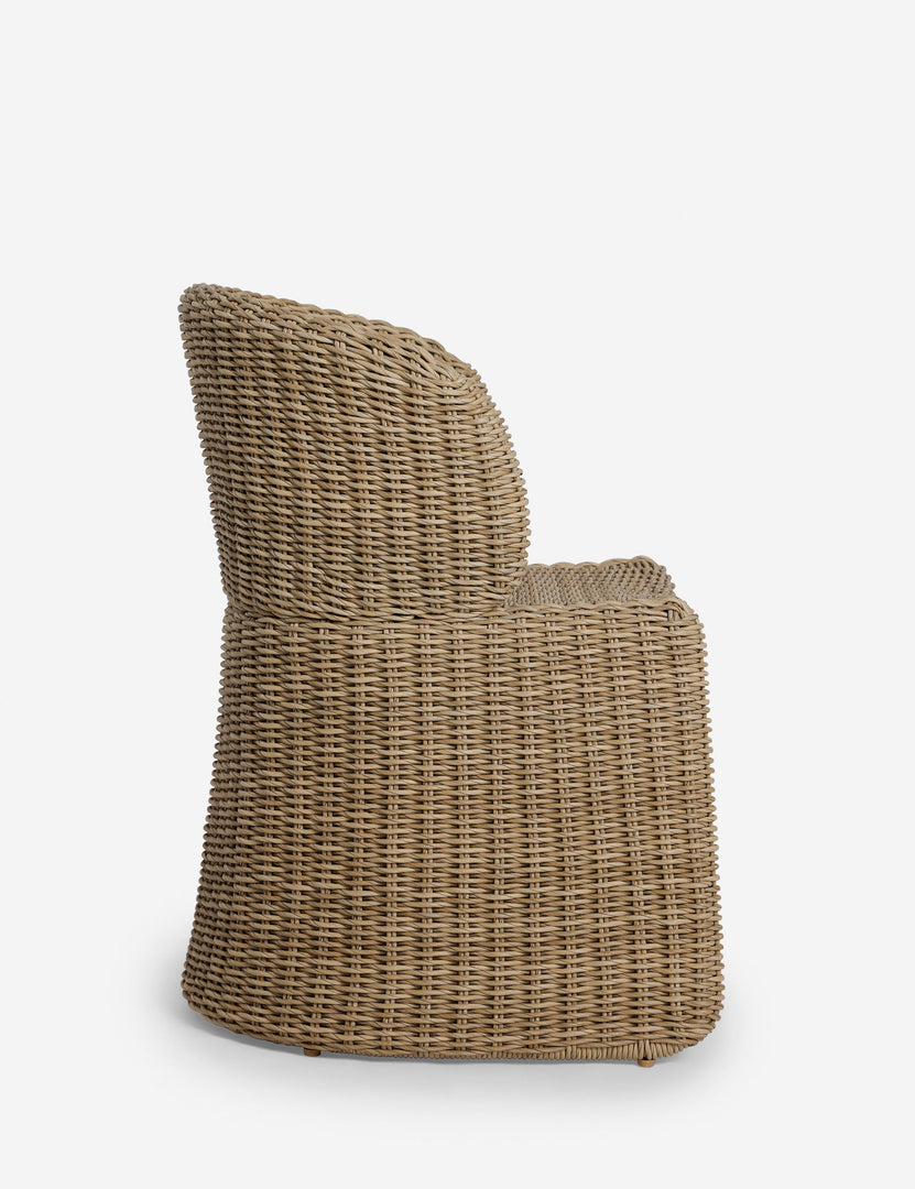 #color::natural | Side profile of the Mettam modern wicker outdoor dining chair.