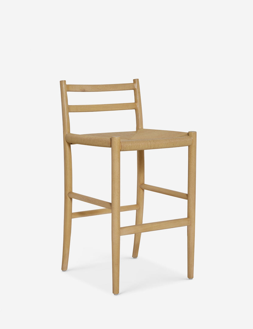 #color::natural-oak | Angled view of the Nicholson slim natural oak wood frame and woven seat counter stool.