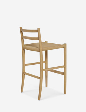 Rear view of the Nicholson slim natural oak wood frame and woven seat counter stool.
