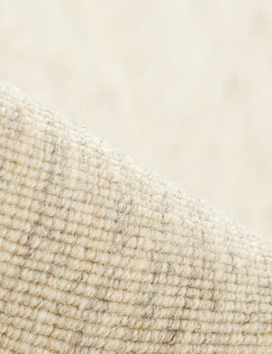 Close up of the Greco low pile wool rug with accent border stitching.