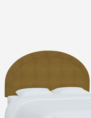 Angled view of the Odele ochre boucle arched headboard