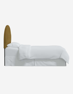 Side of the Odele ochre boucle arched headboard