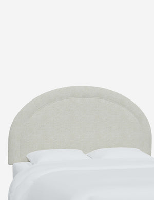 Angled view of the Odele White Boucle arched headboard
