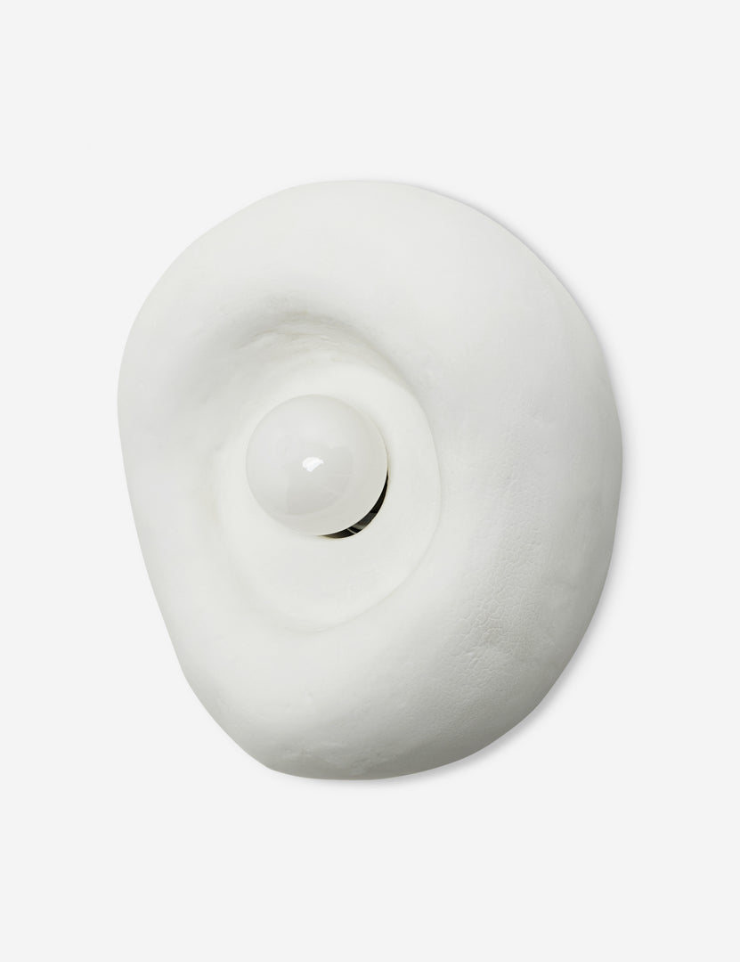 | Angled view of the Odette round matte white sculptural wall sconce