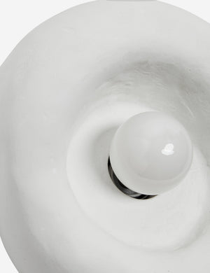 Close up view of the Odette round matte white sculptural wall sconce