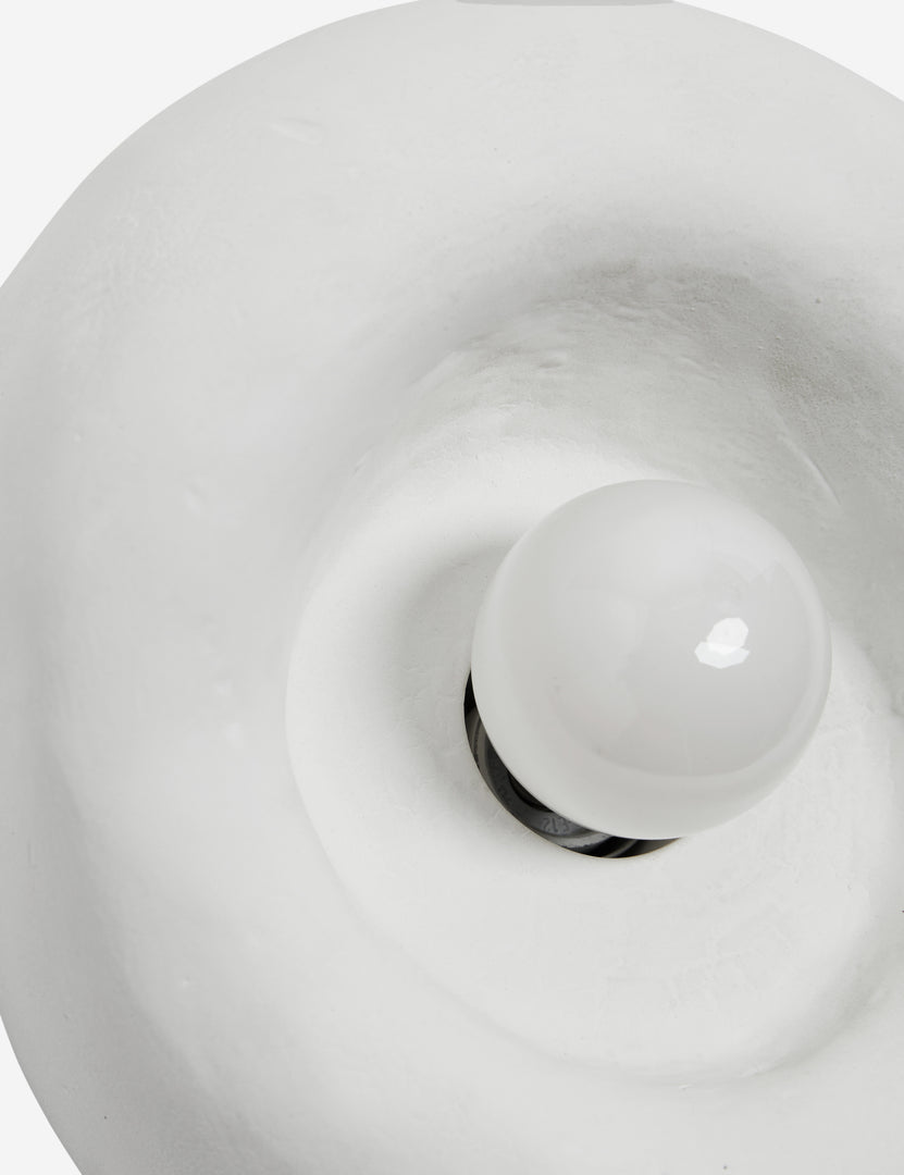 #color::white #size::single | Close up view of the Odette round matte white sculptural wall sconce