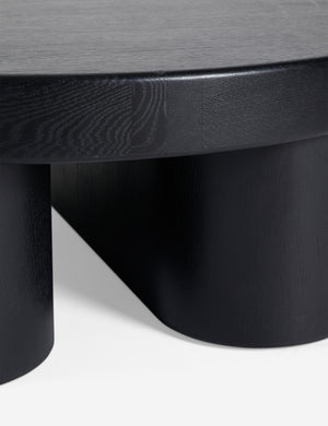 Close up view of Olga round modern black oak coffee table