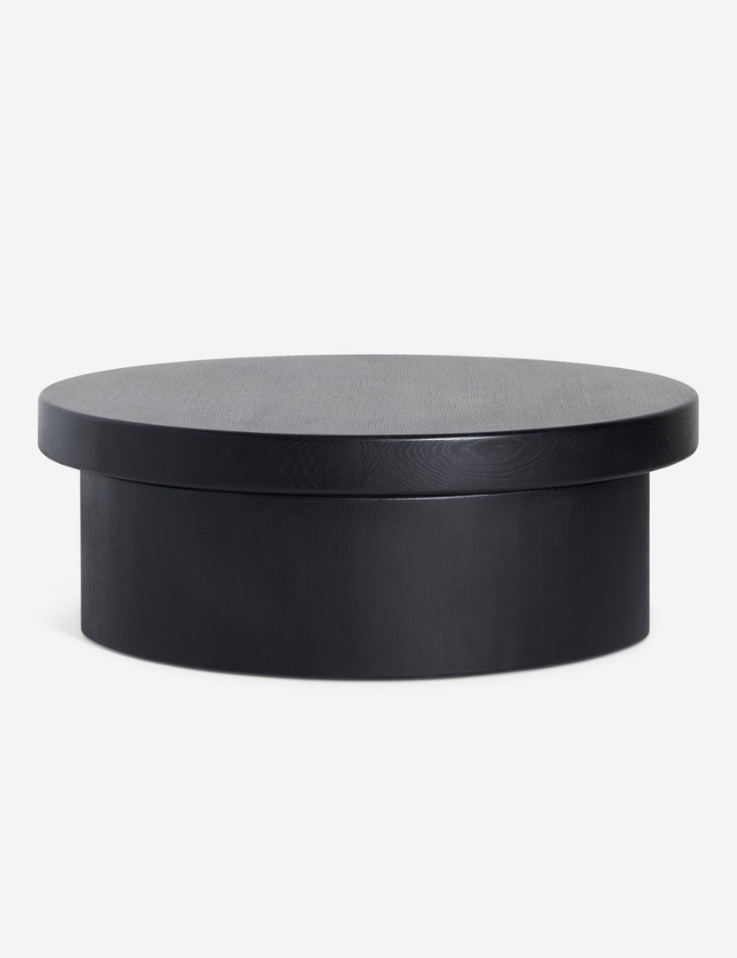 | Side view of Olga round modern black oak coffee table