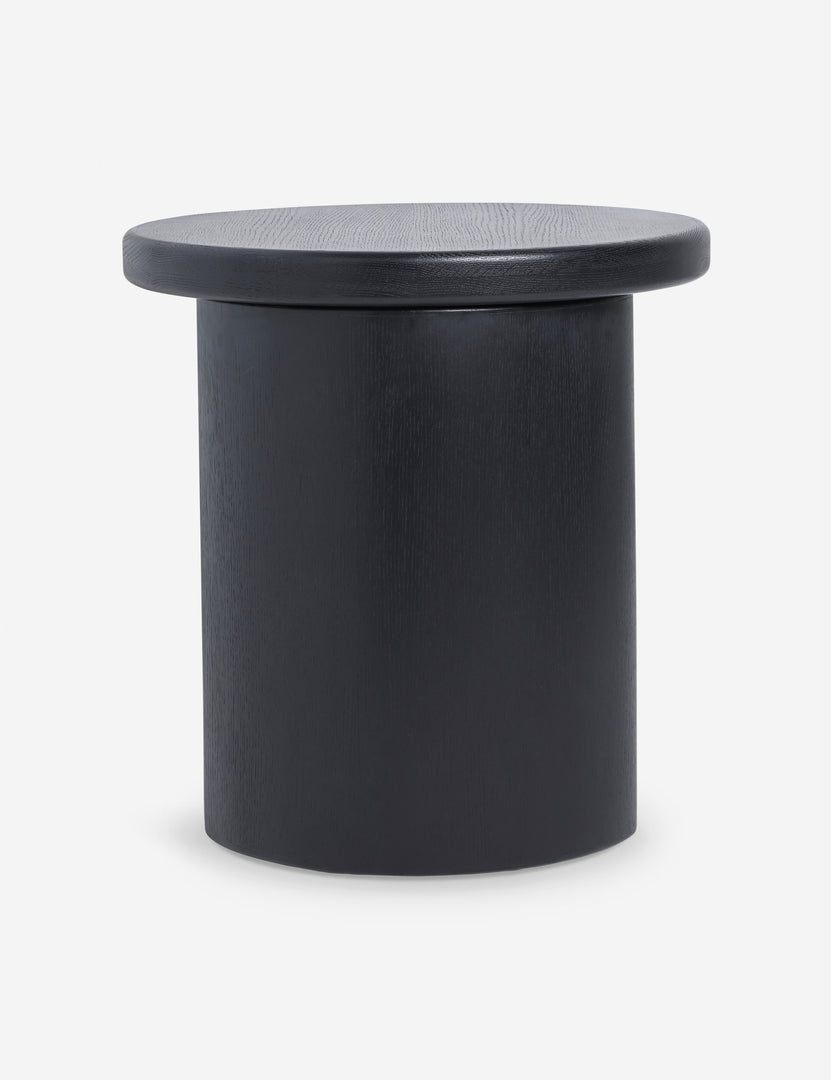 | Side view of the Olga round modern black oak side table