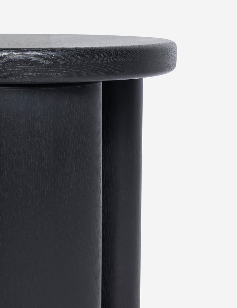 | Close up view of the Olga round modern black oak side table