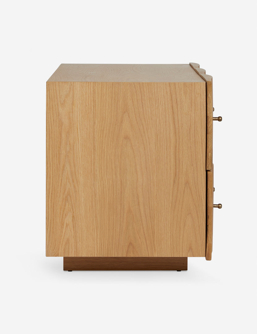 | Side view of the Otelia wide profile two drawer nightstand in natural wood
