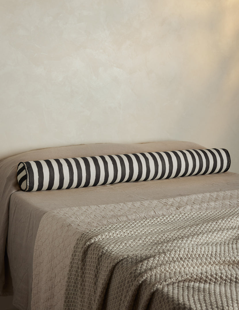 #color::black-and-ivory | Painterly stripe linen long bolster throw pillow in black and ivory styled on a bed