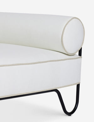 Close up of the Peggy sculptural iron frame and white cushion outdoor accent chair.