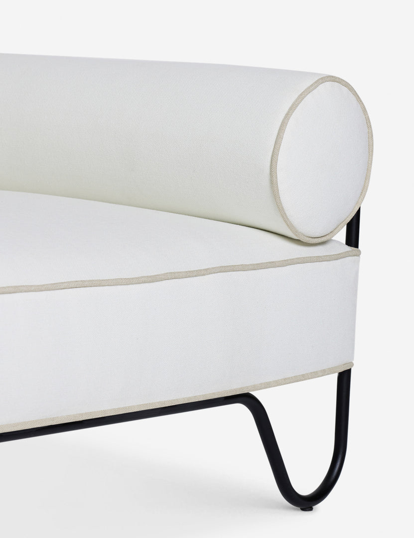 #color::ivory | Close up of the Peggy sculptural iron frame and white cushion outdoor accent chair.