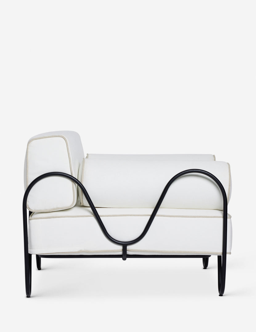 #color::ivory | Side profile of the Peggy sculptural iron frame and white cushion outdoor accent chair.