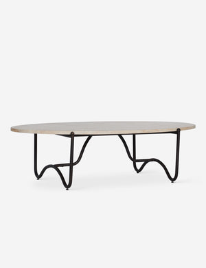 Peggy sculptural iron frame and stone top oval outdoor coffee table.