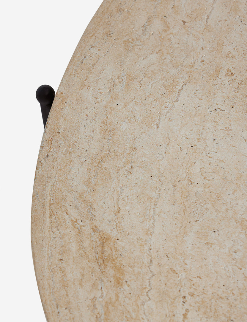 #color::faux-travertine | Close up of the top of the Peggy sculptural iron frame and stone top oval outdoor coffee table.