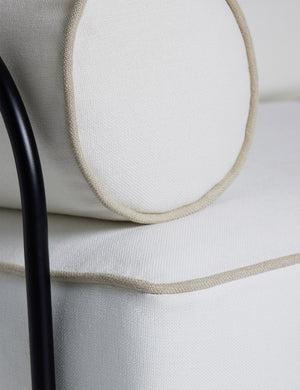 Close up of the Angled view of the Peggy sculptural iron frame and white cushion outdoor sofa.