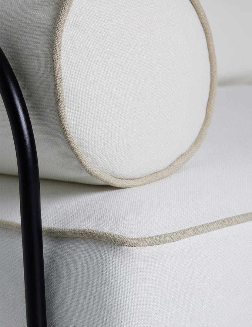 #color::ivory | Close up of the Angled view of the Peggy sculptural iron frame and white cushion outdoor sofa.