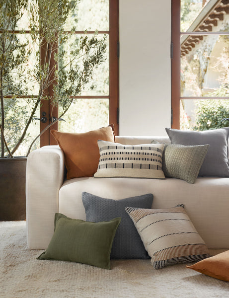 #color::dusty-blue #color::burnt-orange #color::olive | The dusty blue, burnt orange, and olive arlo linen pillows sit together on a plush ivory rug and a natural linen sofa