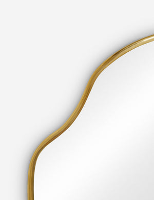 The gold curved frame on the small puddle mirror