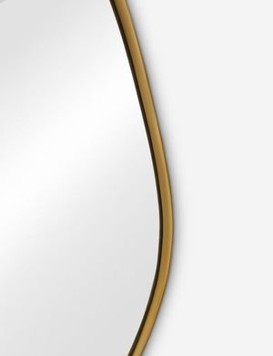 The gold curved frame on the small puddle mirror
