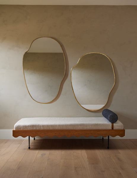 #color::gold  #size::small #size::large | Both sizes of the puddle mirror hang together above a Sarah Sherman Samuel daybed with an ivory cushion and blue pillow