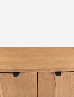 Close up of the handles of the Kono 2-door curved oak cabinet.