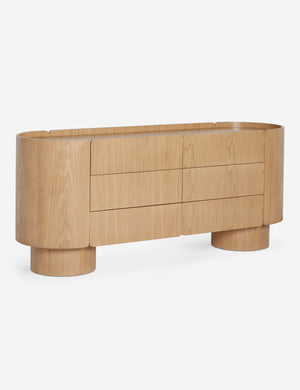Angled view of the Raphael modern natural wood wide six drawer dresser