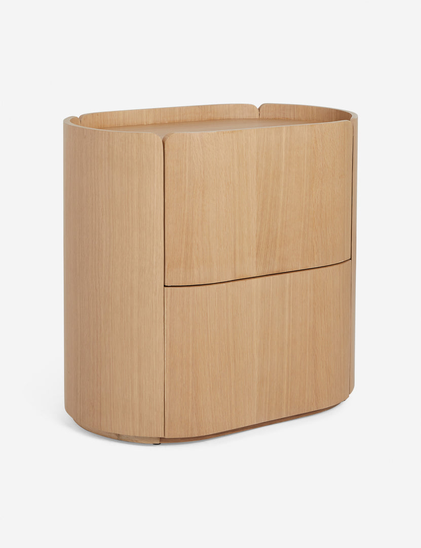 | Angled view of the Raphael modern rounded natural wood two drawer nightstand