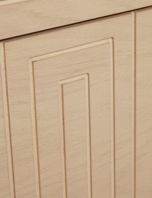 Close up of the Rayner carved linear detailing oak two drawer nightstand.