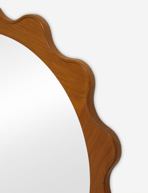 Close up view of the Ripple wavy framed round wall mirror in honey oak