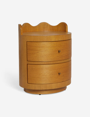 Angled view of the Ripple wavy profile, round two drawer nightstand
