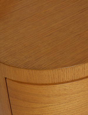 Close up view of the Ripple wavy profile, round two drawer nightstand
