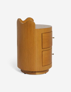 Side view of the Ripple wavy profile, round two drawer nightstand