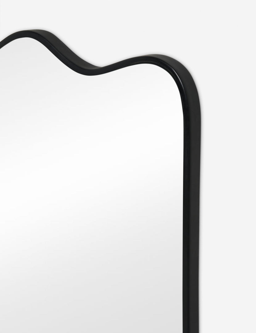 #color::charcoal | Close up view of the Rook wavy slim frame mantel mirror in charcoal