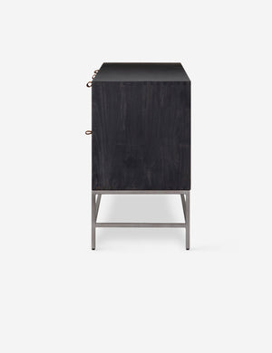 Side view of the Rosamonde black wood sideboard with brown leather pulls and a metal base