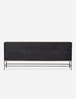 Rear view of the Rosamonde black wood sideboard with brown leather pulls and a metal base