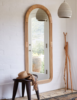 Marsali rattan frame full length mirror hanging on the wall in an entryway