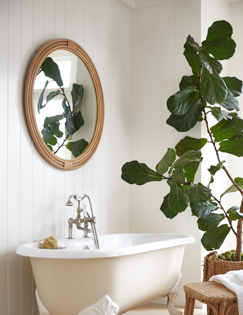 #color::natural #size::large #size::small | Marsali rattan framed round mirror hanging above a clawfoot bathtub