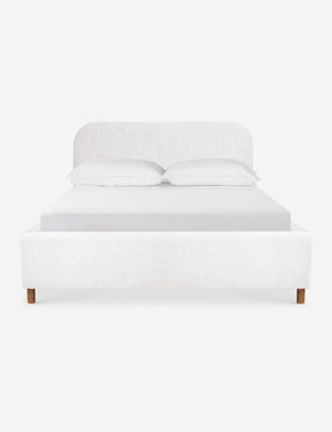 Solene White linen platform bed with an arched headboard and oak wood legs
