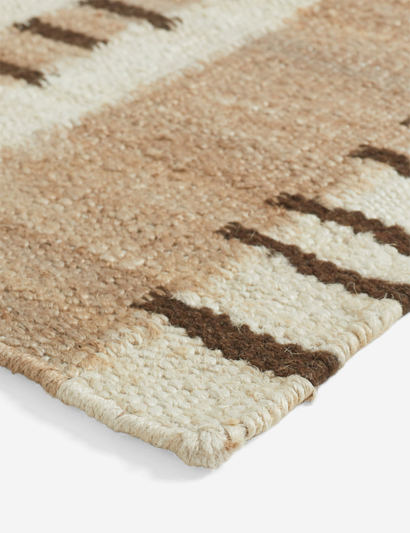 | Close up view of the corner of the Tempo Flatweave Jute Rug by Elan Byrd.