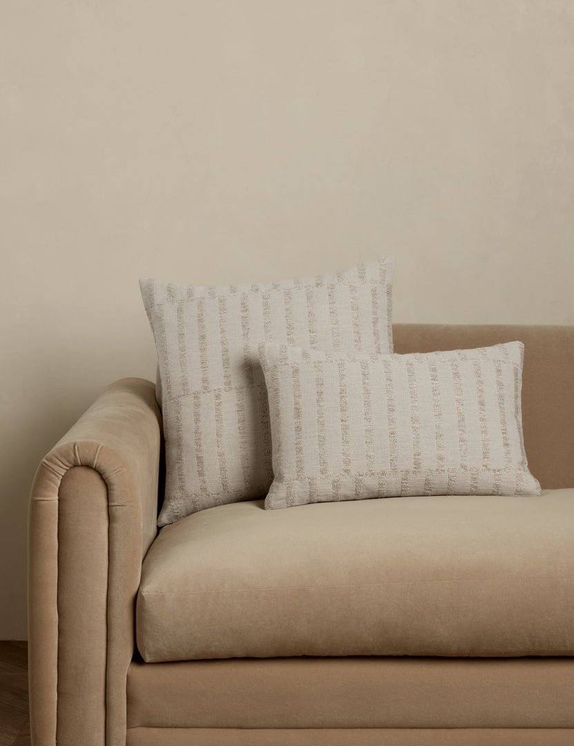 #color::natural #style::square #style::lumbar | Thisbe offset stripe throw and lumbar pillows paired together on a sofa.
