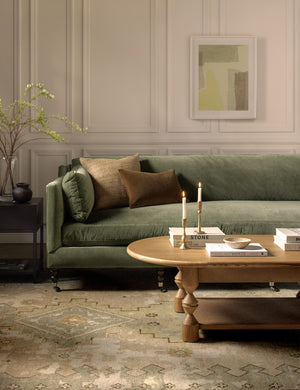 Fabienne moss green velvet plush couch with decorative legs.