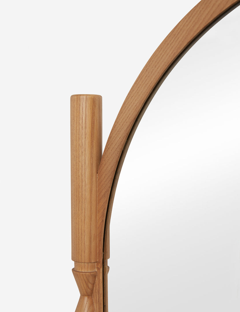 #color::natural | Close up of the top of the Topia arched carved wood frame floor mirror by Ginny Macdonald in natural.