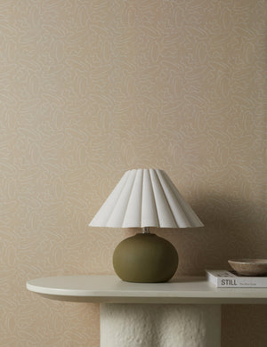 Topos Abstract Line Patterned Wallpaper by Élan Byrd on a wall behind a console table styled with a small table lamp.