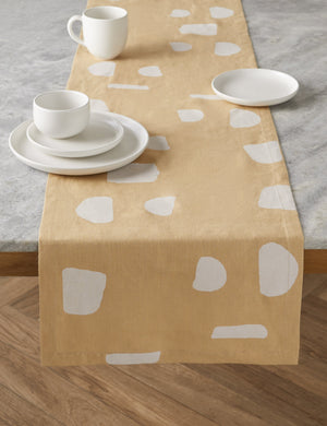 The Pacifica salt white Dinnerware 5-Piece Place Setting by Casafina sits atop a yellow and white patterned table running atop a stone table