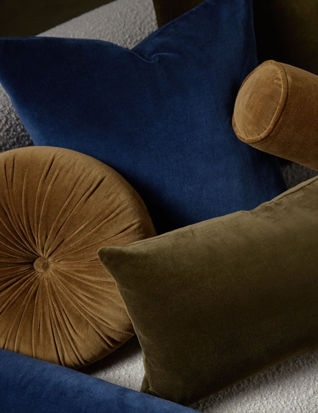 #color::olive #style::lumbar | Charlotte velvet pillow in olive and true blue sit on a cream boucle lounger with other velvet pillows