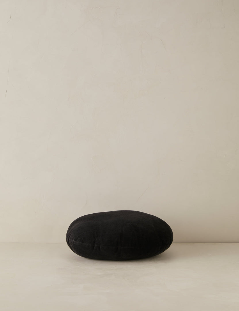 #color::black | Velvet round accent pillow in black laying flat